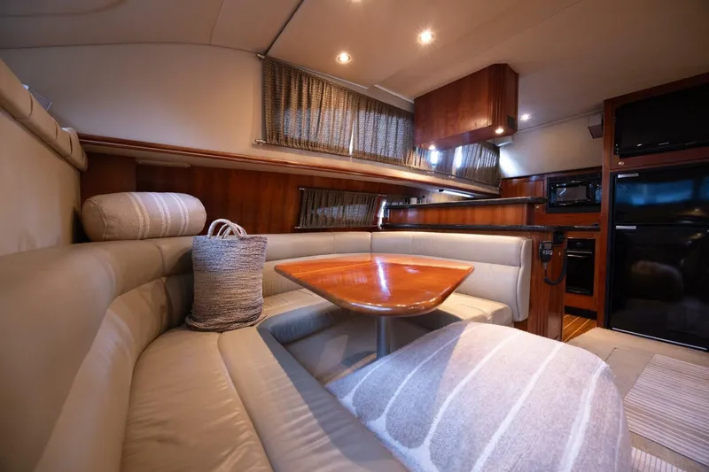 Sky Brown Yacht Photos Pics Luxurious interior of 2005 Cruisers Yachts 455 Express Motoryacht with elegant seating and dining area.