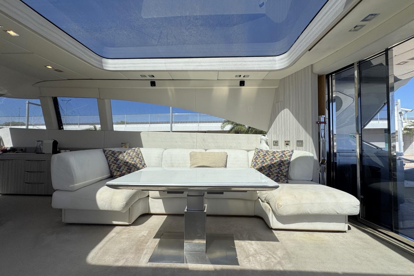 Luxurious yacht interior with white seating, glass table, and large windows, AB 78 model, 2007.