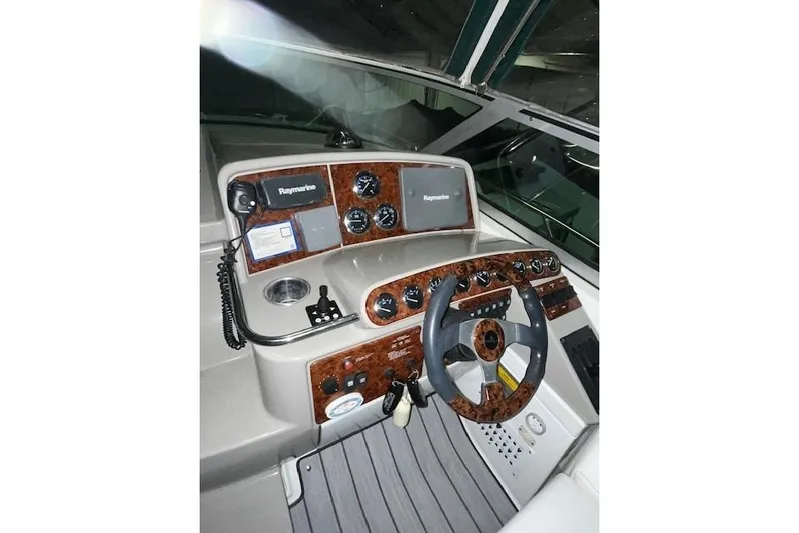  Yacht Photos Pics 2004 Formula 34 Performance Cruiser helm with Raymarine electronics and woodgrain dashboard.