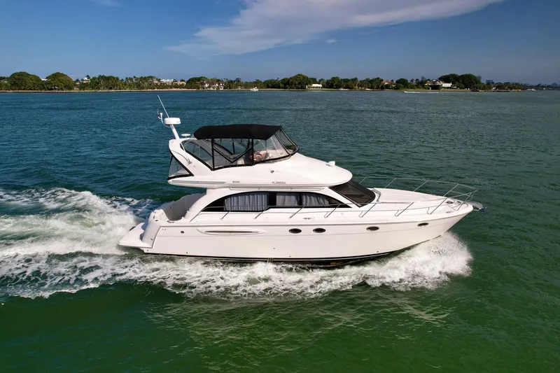 Vrpro Yacht Photos Pics 2007 Meridian 411 Sedan cruising on a serene waterway under a clear sky.