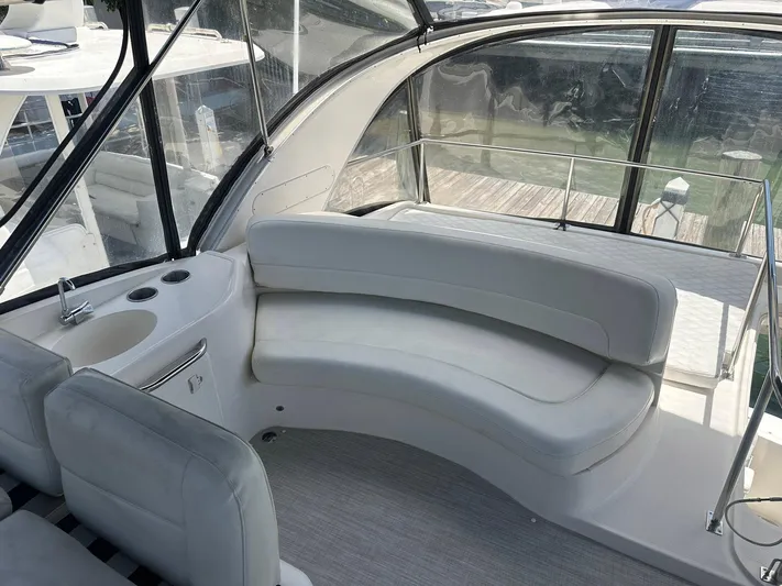 Vrpro Yacht Photos Pics 2007 Meridian 411 Sedan interior with curved white seating and windows.