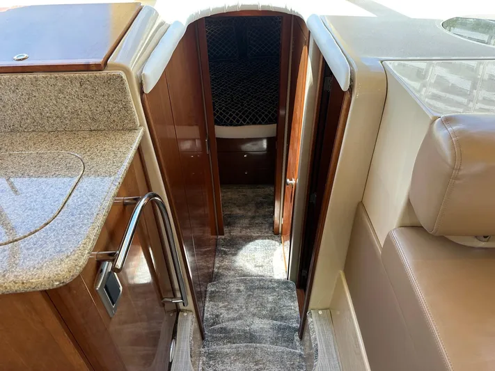 Vrpro Yacht Photos Pics Interior view of a 2007 Meridian 411 Sedan yacht, featuring a carpeted stairway and wooden cabinetry.