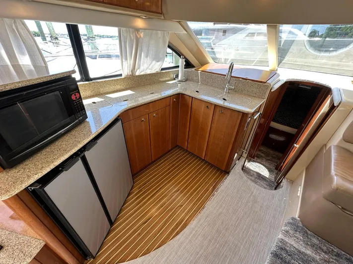 Vrpro Yacht Photos Pics Interior of 2007 Meridian 411 Sedan yacht kitchen with wood cabinets and modern appliances.