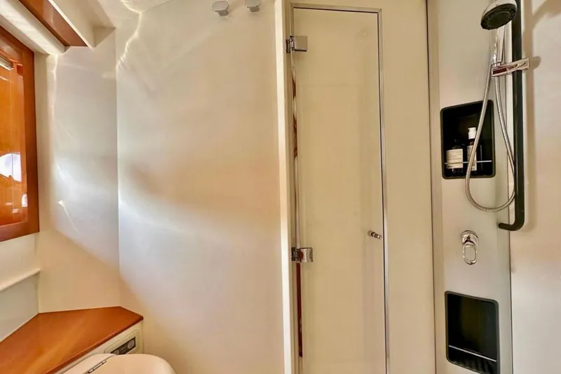  Yacht Photos Pics Luxurious bathroom interior of 2007 Pershing 50 yacht with modern shower and wooden accents.