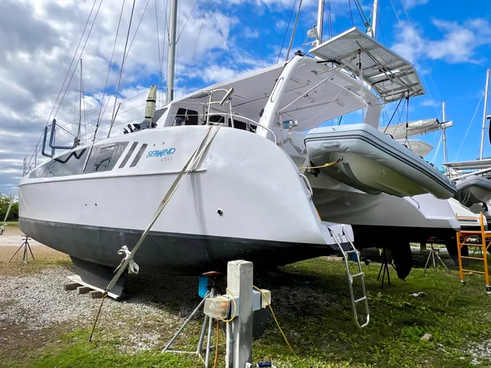 Kestrel Yacht Photos Pics 2020 Seawind 1260 catamaran on land, featuring a sleek design and attached dinghy.