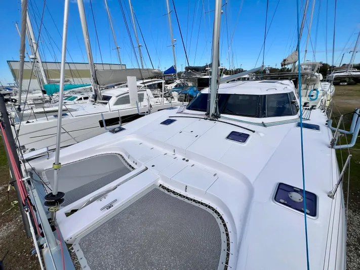 Kestrel Yacht Photos Pics 2020 Seawind 1260 catamaran docked among other boats, showcasing sleek design and spacious deck.