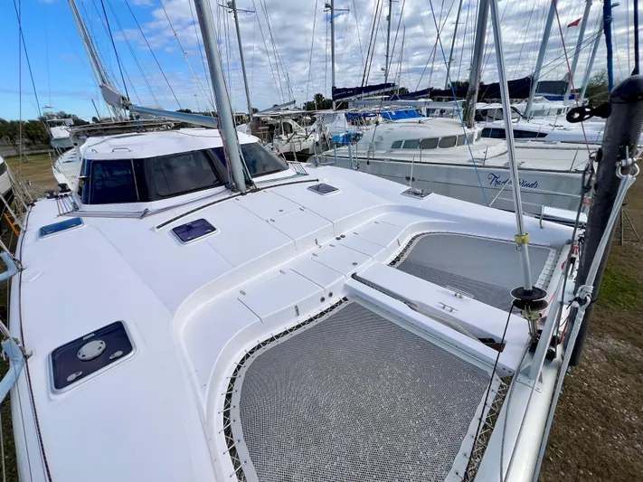 Kestrel Yacht Photos Pics 2020 Seawind 1260 catamaran with sleek design, docked among other boats.