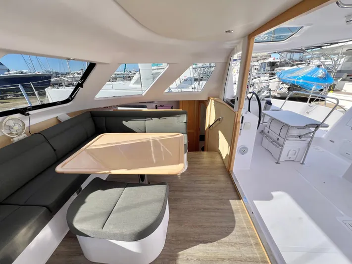 Kestrel Yacht Photos Pics Seawind 1260 catamaran interior, featuring a modern dining area and outdoor view, 2020 model.