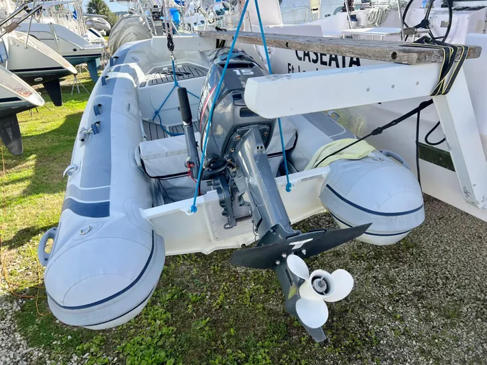 Kestrel Yacht Photos Pics Inflatable boat with outboard motor, docked on grass near Seawind 1260 catamaran, 2020 model.