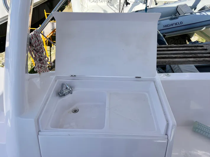 Kestrel Yacht Photos Pics Seawind 1260 2020 yacht sink with open lid, docked near other boats.