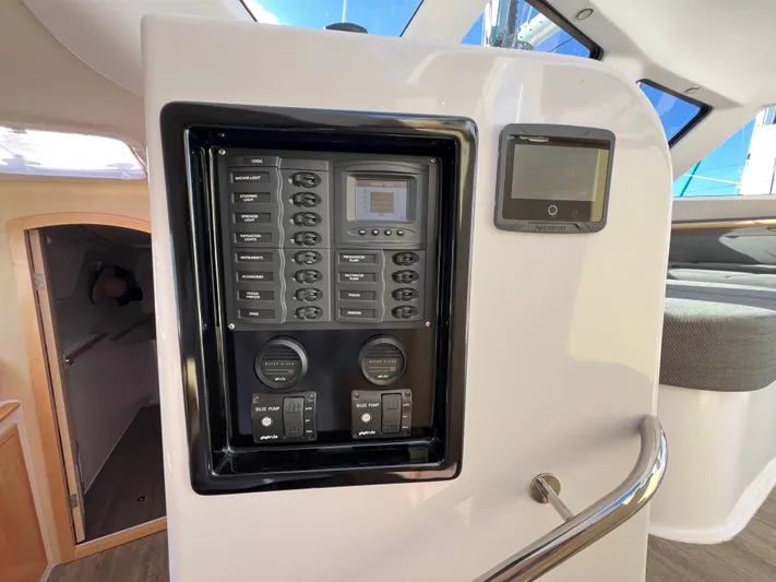 Kestrel Yacht Photos Pics Control panel inside a 2020 Seawind 1260 catamaran, featuring navigation and system controls.