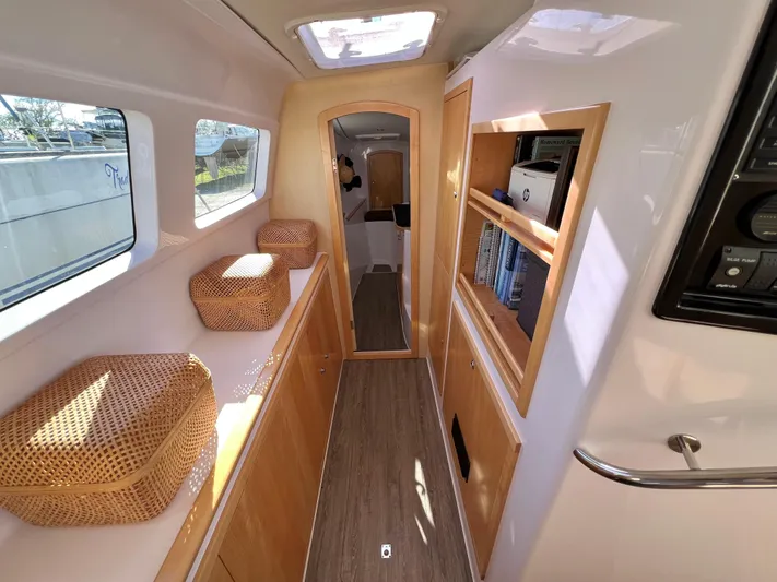 Kestrel Yacht Photos Pics Interior of 2020 Seawind 1260 catamaran with wooden cabinetry and wicker baskets.