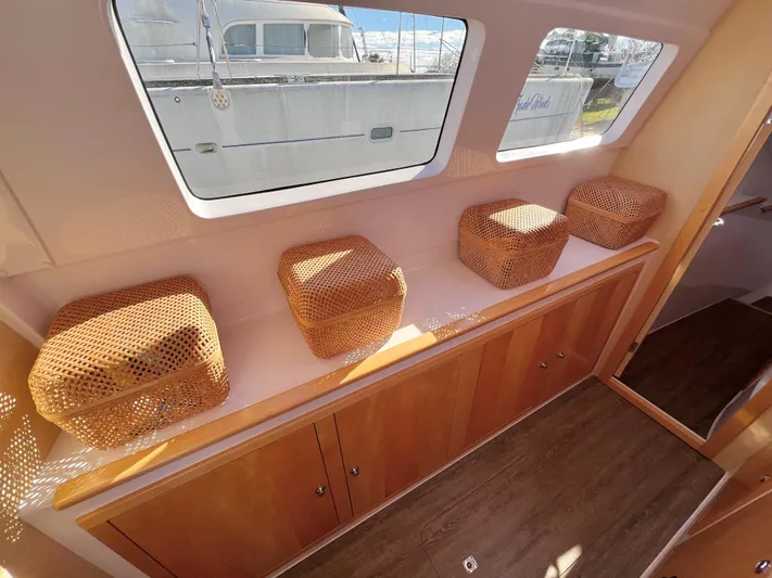 Kestrel Yacht Photos Pics Interior of 2020 Seawind 1260 catamaran with wicker cushions and large windows.