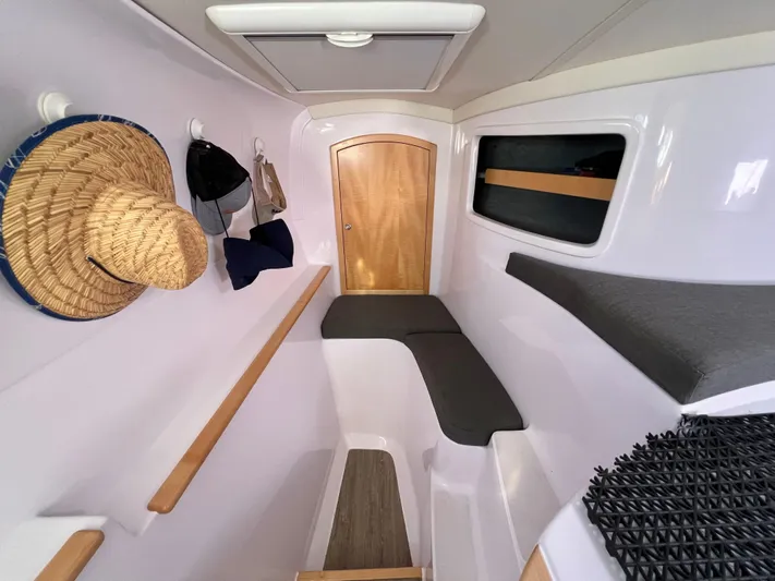 Kestrel Yacht Photos Pics Interior of 2020 Seawind 1260 yacht, featuring seating, storage, and hanging hats.