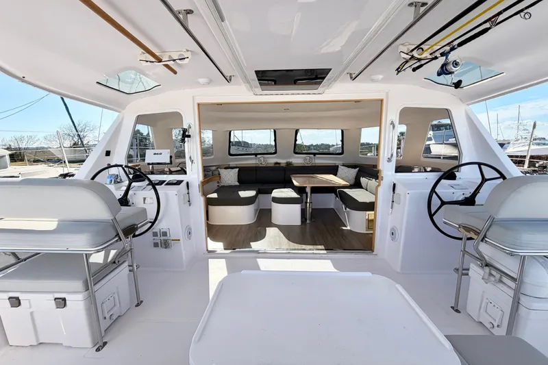 Kestrel Yacht Photos Pics 2020 Seawind 1260 catamaran interior with dual helm stations and spacious seating area.