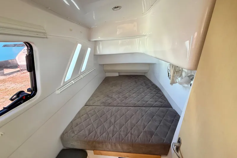 Kestrel Yacht Photos Pics Interior cabin of 2020 Seawind 1260 catamaran with cozy bed and windows.