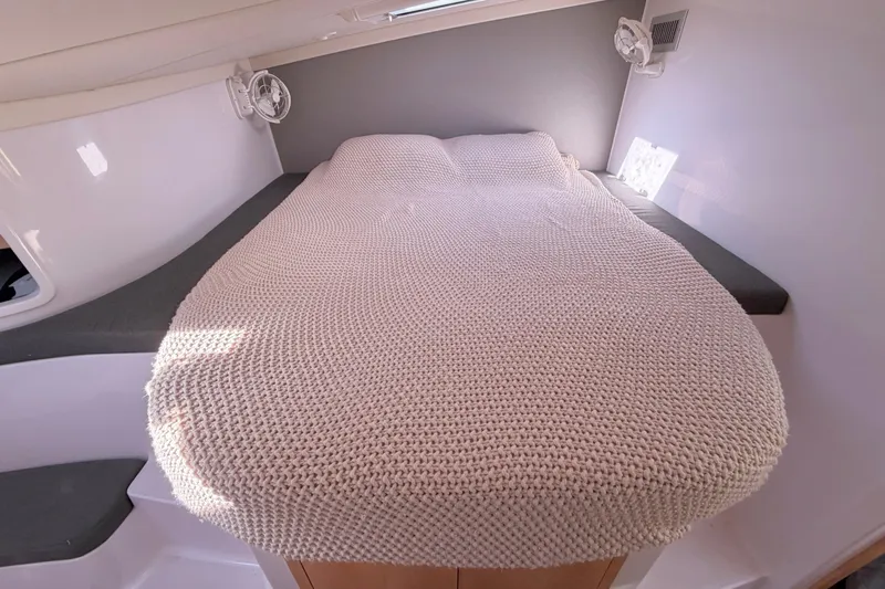 Kestrel Yacht Photos Pics Cozy cabin bed in 2020 Seawind 1260 catamaran with knitted blanket.