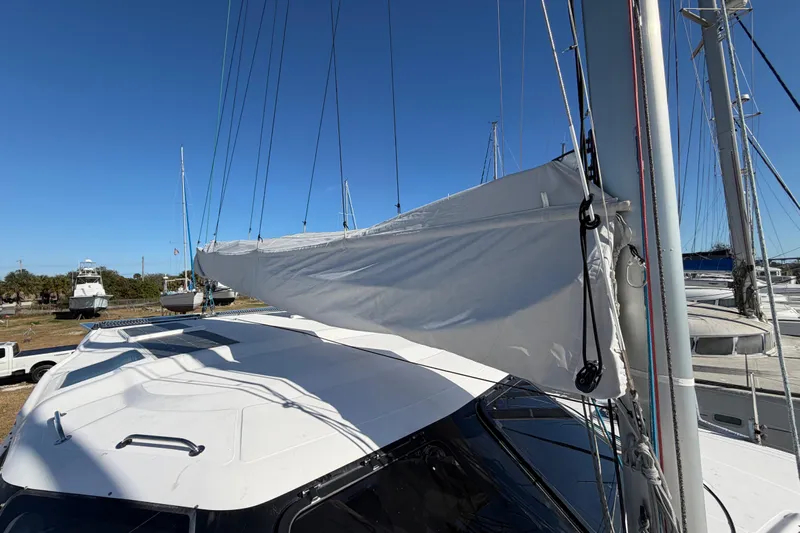 Kestrel Yacht Photos Pics 2020 Seawind 1260 catamaran with sails, docked under clear blue sky.