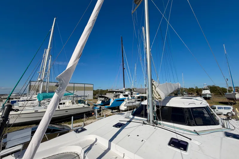 Kestrel Yacht Photos Pics 2020 Seawind 1260 catamaran docked among other sailboats under clear blue sky.