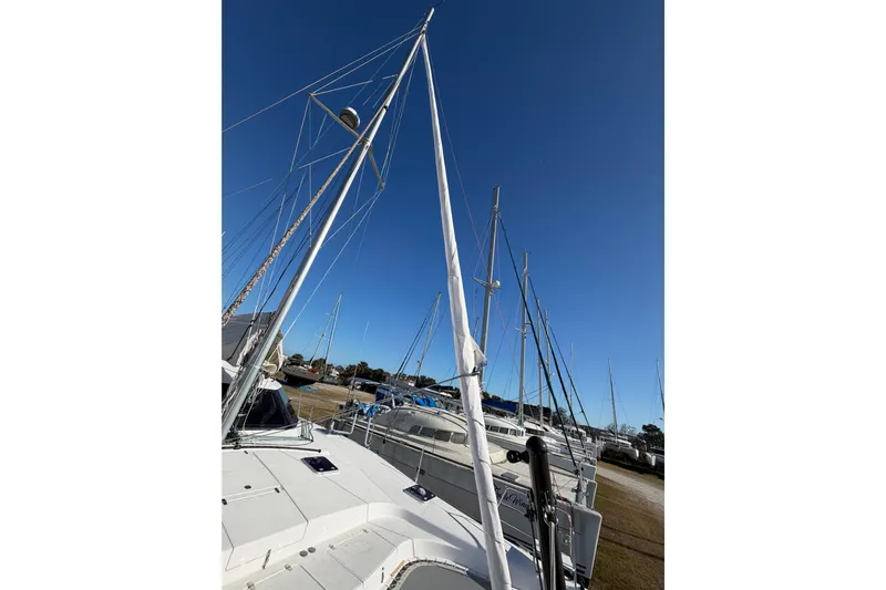 Kestrel Yacht Photos Pics 2020 Seawind 1260 catamaran with mast, docked under clear blue sky.