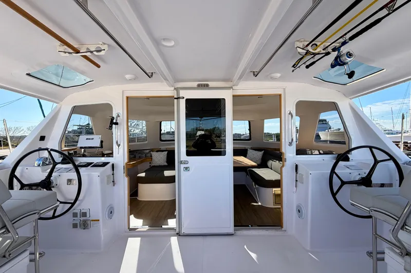 Kestrel Yacht Photos Pics 2020 Seawind 1260 catamaran interior with dual steering wheels and spacious seating area.