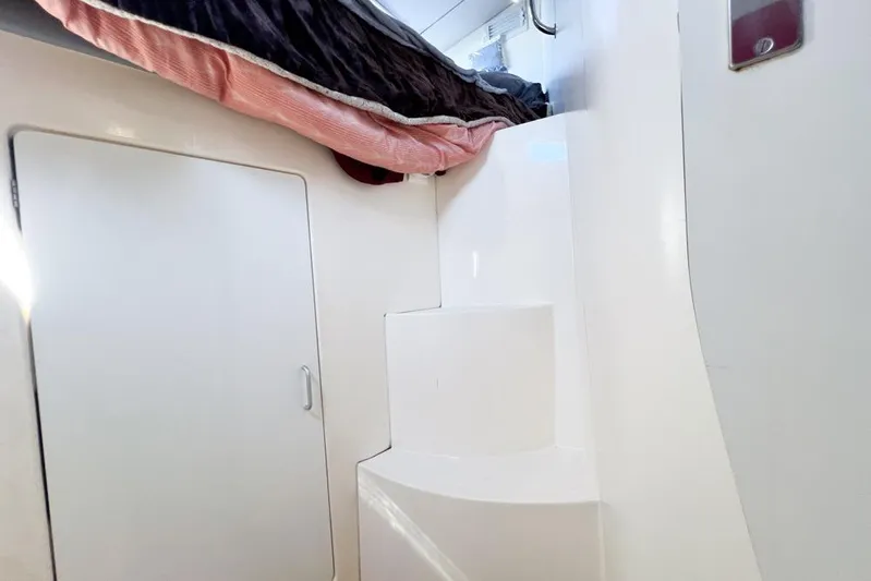 Next Of Kin Yacht Photos Pics Interior of a 2000 Leopard 38 catamaran with white steps and a closed door.