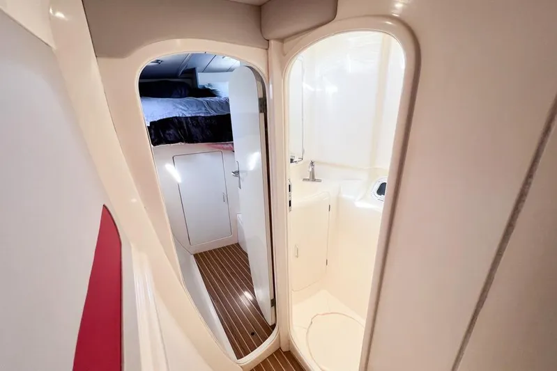 Next Of Kin Yacht Photos Pics Interior of 2000 Leopard 38 yacht showing cabin and bathroom with wooden flooring.