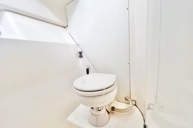 Next Of Kin Yacht Photos Pics Compact marine toilet in a 2000 Leopard 38 catamaran bathroom.