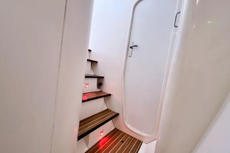 Next Of Kin Yacht Photos Pics Staircase with red lights leading to a door inside a 2000 Leopard 38 yacht.