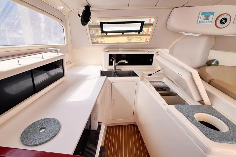 Next Of Kin Yacht Photos Pics Interior of a 2000 Leopard 38 yacht kitchen with sink and storage.