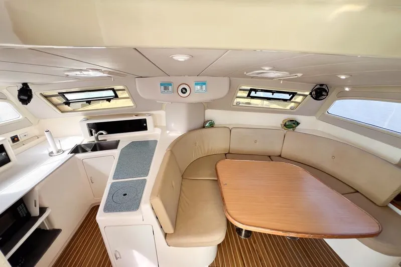 Next Of Kin Yacht Photos Pics Interior of 2000 Leopard 38 catamaran with kitchen and seating area.