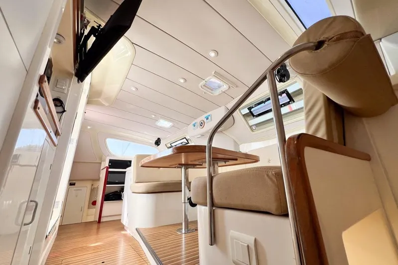 Next Of Kin Yacht Photos Pics Interior of a 2000 Leopard 38 catamaran, featuring modern seating and wooden accents.