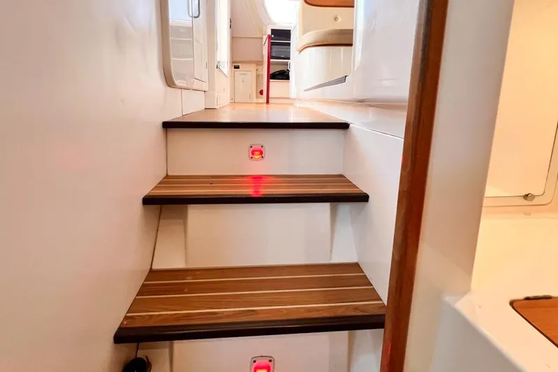 Next Of Kin Yacht Photos Pics Staircase inside 2000 Leopard 38 yacht with wooden steps and modern design.