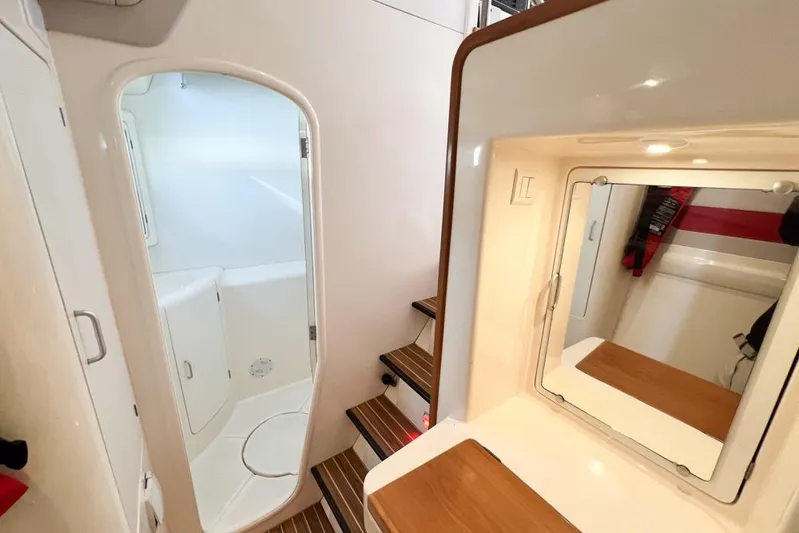 Next Of Kin Yacht Photos Pics Interior of 2000 Leopard 38 yacht with bathroom and wooden steps.