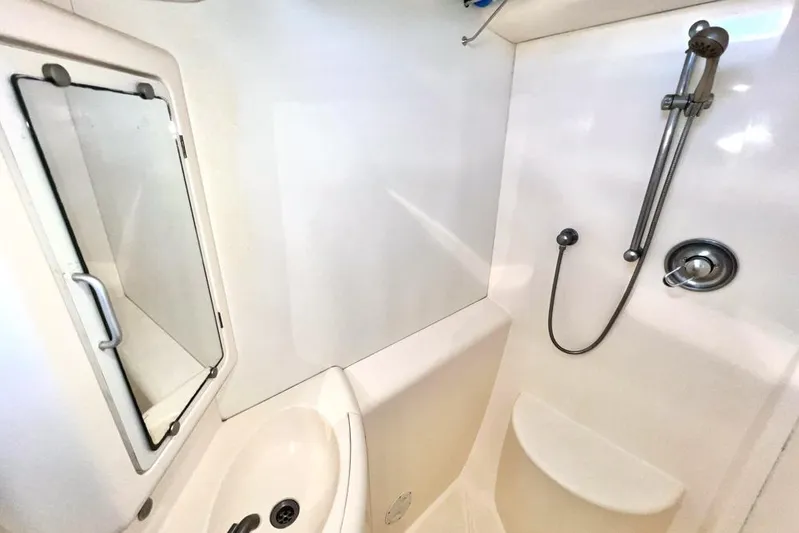 Next Of Kin Yacht Photos Pics Compact bathroom in a 2000 Leopard 38 yacht with shower and sink.