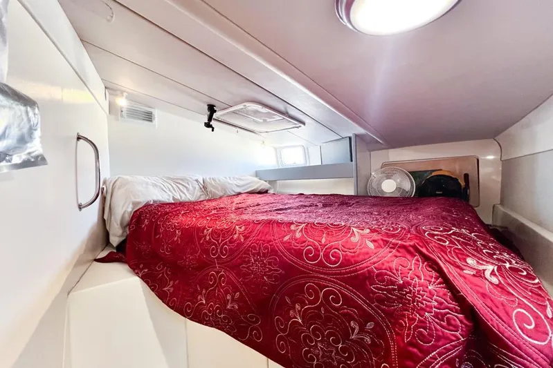 Next Of Kin Yacht Photos Pics Cozy cabin interior of 2000 Leopard 38 yacht with red bedding and natural light.