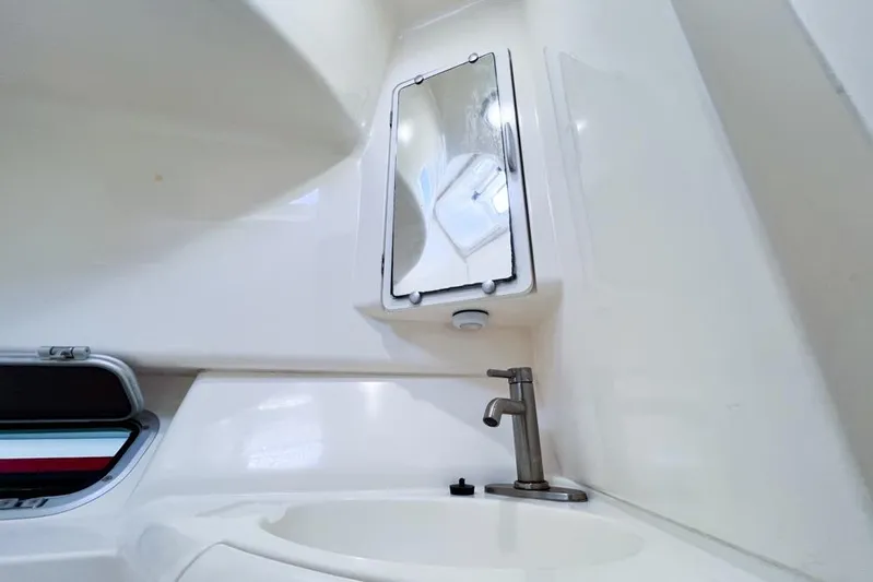 Next Of Kin Yacht Photos Pics Interior of a 2000 Leopard 38 yacht bathroom with sink and mirror.