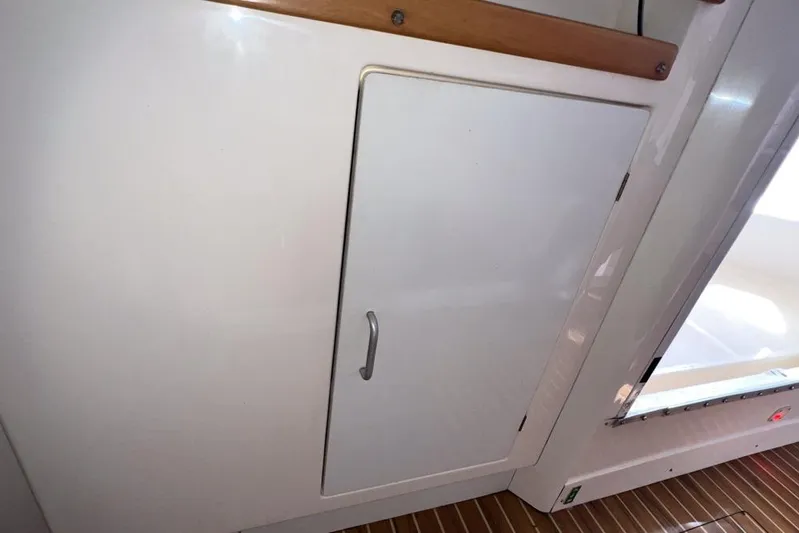 Next Of Kin Yacht Photos Pics White cabinet door on a 2000 Leopard 38 yacht interior.