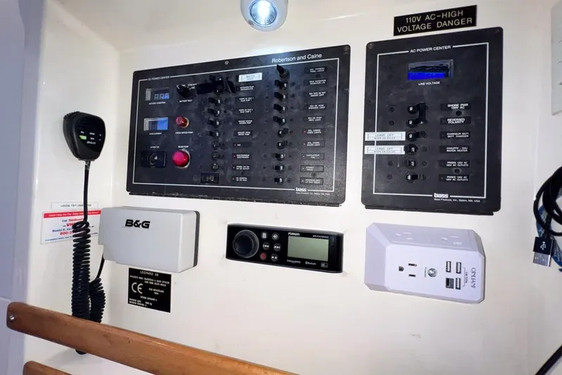 Next Of Kin Yacht Photos Pics Electrical control panel on a 2000 Leopard 38 catamaran with various switches and outlets.