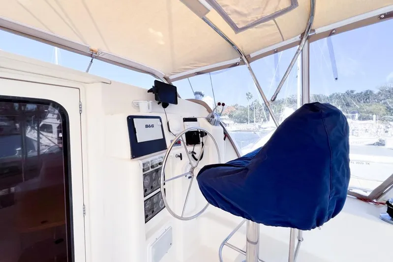 Next Of Kin Yacht Photos Pics Helm station of 2000 Leopard 38 catamaran with covered seat and navigation equipment.