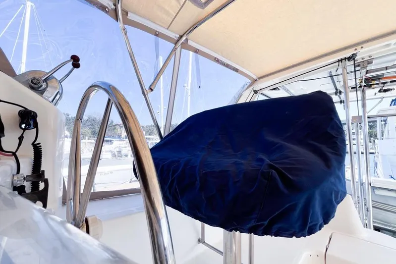 Next Of Kin Yacht Photos Pics Covered helm station on a 2000 Leopard 38 catamaran, featuring stainless steel wheel.