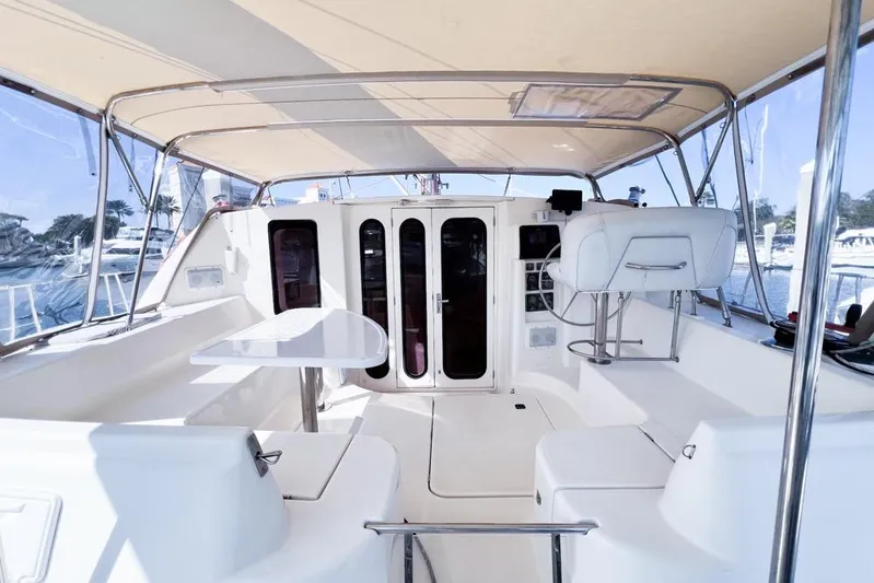 Next Of Kin Yacht Photos Pics Spacious interior of a 2000 Leopard 38 catamaran with seating and helm station.