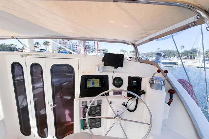 Next Of Kin Yacht Photos Pics Helm of 2000 Leopard 38 catamaran with navigation equipment and steering wheel.