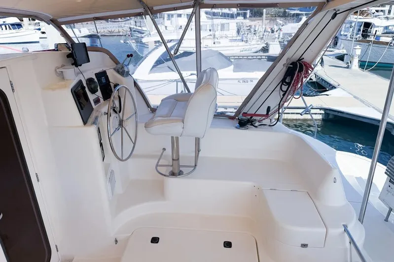 Next Of Kin Yacht Photos Pics Interior view of a 2000 Leopard 38 yacht cockpit with steering wheel and seating.