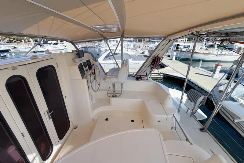 Next Of Kin Yacht Photos Pics Interior view of a 2000 Leopard 38 catamaran at a marina dock.