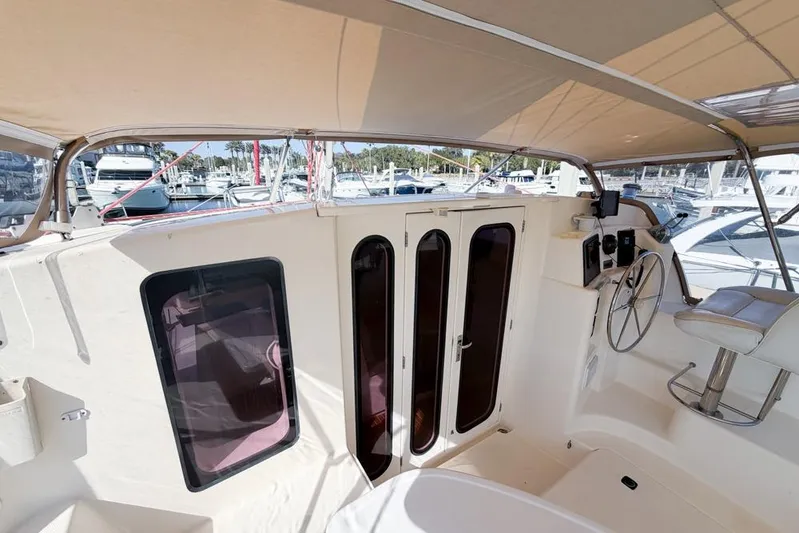 Next Of Kin Yacht Photos Pics Interior view of a 2000 Leopard 38 catamaran with helm and seating area.