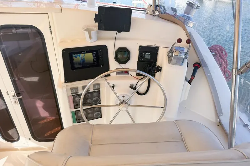 Next Of Kin Yacht Photos Pics Helm of a 2000 Leopard 38 catamaran with navigation equipment and steering wheel.
