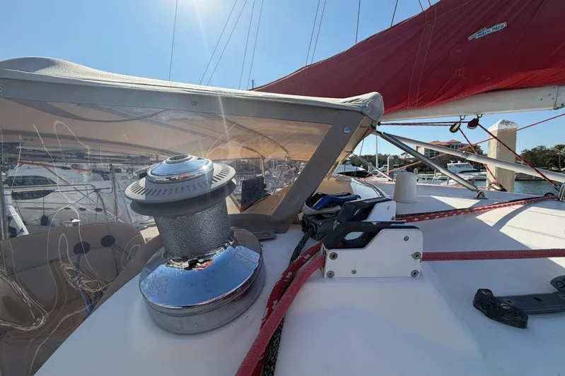 Next Of Kin Yacht Photos Pics Sailing yacht deck with winch and red sail, Leopard 38, 2000 model.