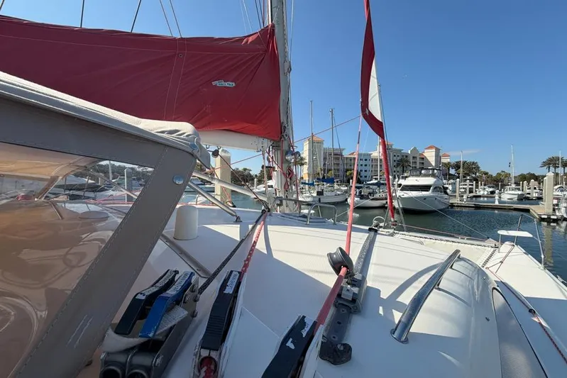 Next Of Kin Yacht Photos Pics Sailboat Leopard 38, 2000 model, docked in marina with red sails and clear blue sky.