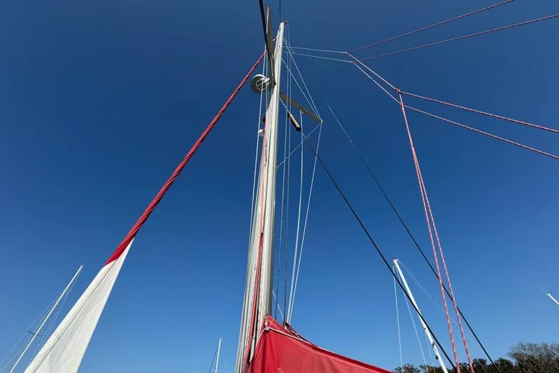 Next Of Kin Yacht Photos Pics Sailboat mast and rigging against clear blue sky, Leopard 38, 2000 model.